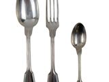 three spoons and a fork sitting next to each other