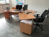 a desk with two computers and a chair in a room
