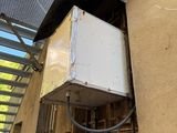 a white box attached to the side of a building