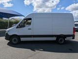 the white van is parked in a parking lot with a blue sky in the background