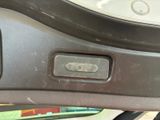 a close up of a car door handle with a button on it