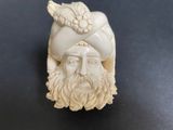an old carved figurine of a man with a hat and beard