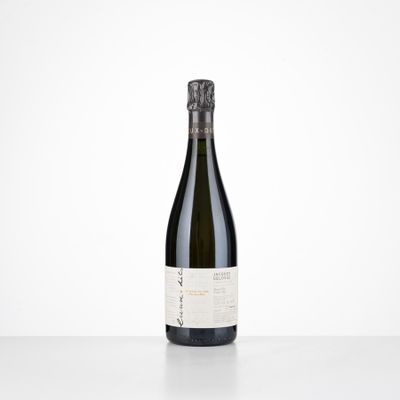 a bottle of wine sitting on top of a white table