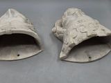 two pieces of pottery that are on a table