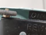 a close up view of a metal object with a screw on it