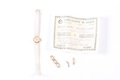a watch and a pair of scissors on a white surface