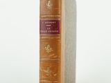 an old book sitting on top of a white surface