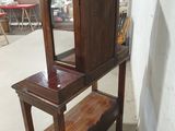 a wooden cabinet with a mirror on top of it
