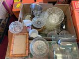 a box full of glass dishes and bowls on the floor