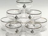 six clear glass bowls with black rims and a monogrammed monogram