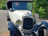 a vintage car parked on the side of the road