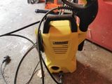 a yellow and black power washer sitting on the floor
