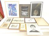 a lot of framed pictures on a table in a room