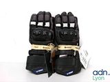 pair of black motorcycle gloves on a white background with a tag