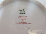 a white plate with a black and red design on it