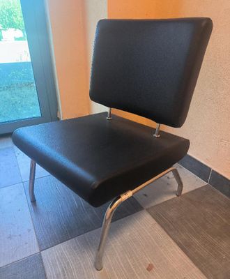 a black chair that is sitting in front of a door