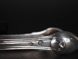 a silver spoon and a spoon rest on a table
