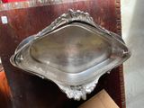a silver tray sitting on top of a wooden table