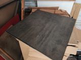 a pile of cardboard and cardboard boxes in a garage