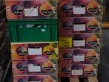 several boxes of fruit are stacked on pallets in a store