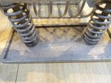 a close up of a metal object with springs on it