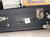 a black suitcase sitting on the floor next to a box