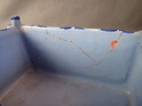 a blue bowl with rust on it sitting on a table