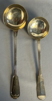 two spoons that are sitting on a table