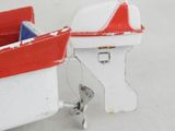 a small toy boat with a red and white roof