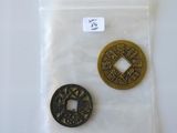 two coins in a bag on a white surface