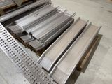 several pieces of metal are stacked on a pallet in a warehouse