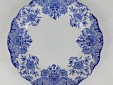 a blue and white plate with a floral design on it
