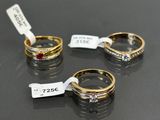 three gold rings with diamonds and a price tag on a table