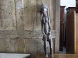 a statue of a monkey sitting on a wooden table
