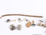 many different types of jewelry on a white surface