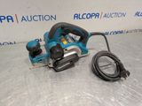 a close up of a blue and black electric planer on a table