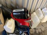 a red and black blower sitting next to a container of milk