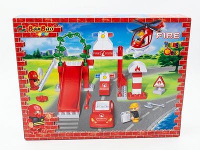 a toy fire station with a fire truck and a fire hydrant