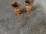 two vases that are sitting on a table
