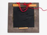 a picture of a blackboard with a red string hanging from it