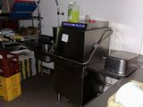 a kitchen with a sink, stove, and other items in it