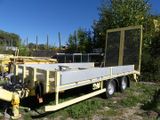 a yellow trailer that is parked in the grass
