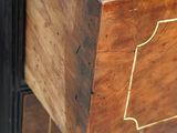 a wooden chest of drawers that has a drawer on top of it