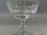 a clear glass bowl on a table with a gray background
