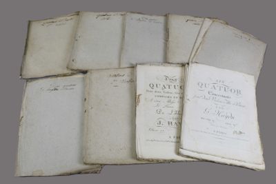 several old books are stacked on top of each other on a table
