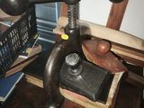 a wooden table topped with books and a metal object