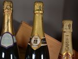 three bottles of champagne sitting on a table next to each other