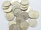 coins are scattered on a white surface with a small amount of them