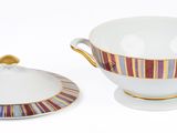 a bowl and saucer sitting next to each other on a white surface