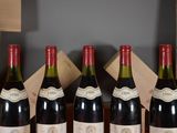 several bottles of wine are lined up on a table